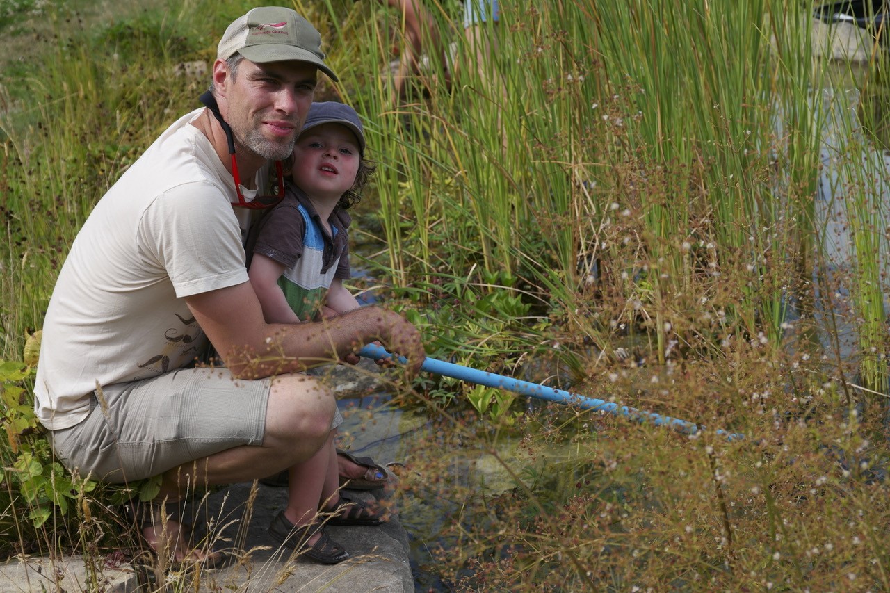 Nick Stanger and child in marsh ecosystem