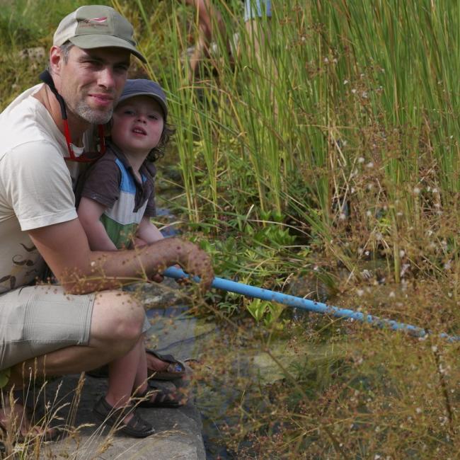 Nick Stanger and child in marsh ecosystem